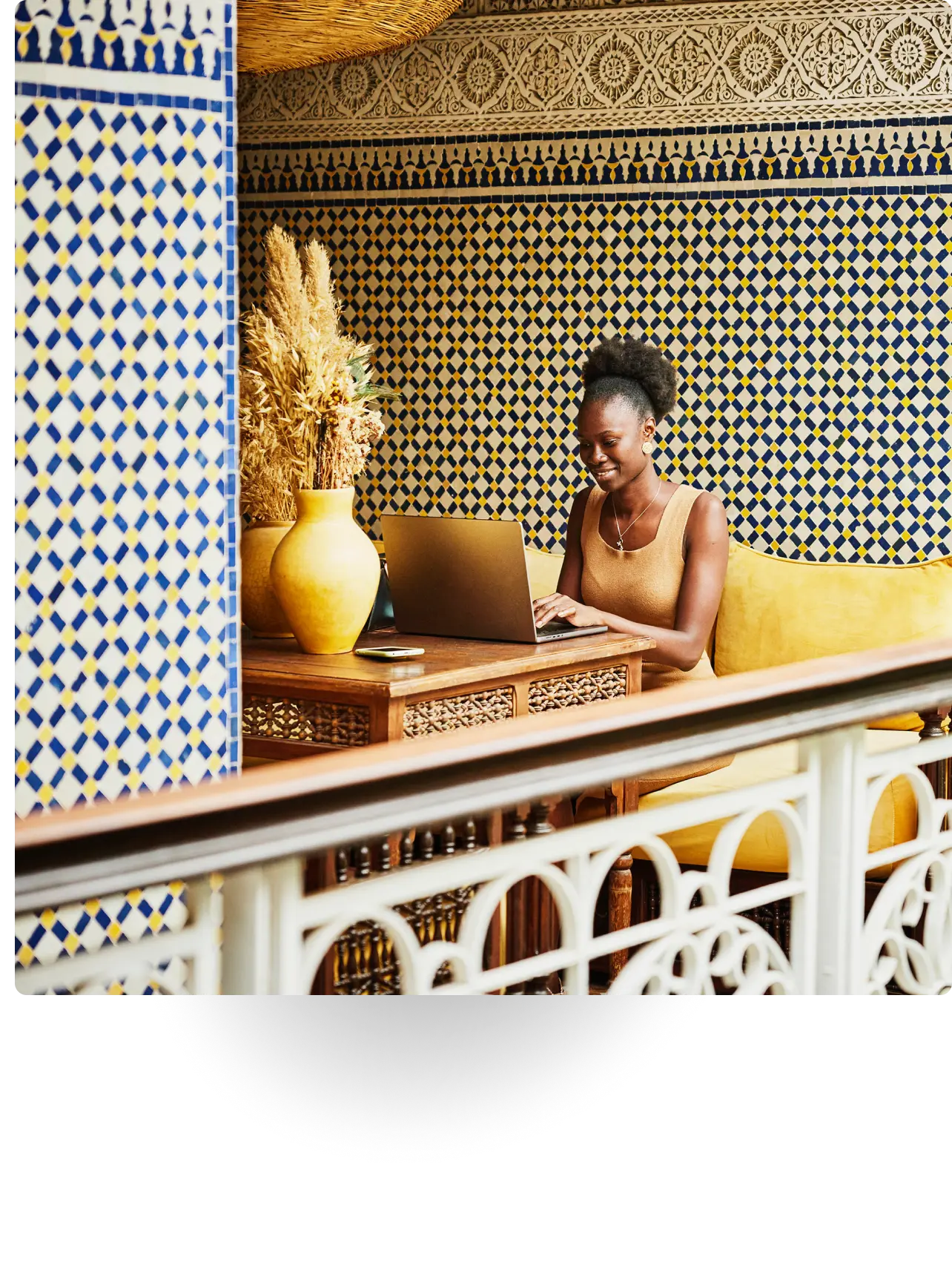 Smiling woman working on a laptop at a table