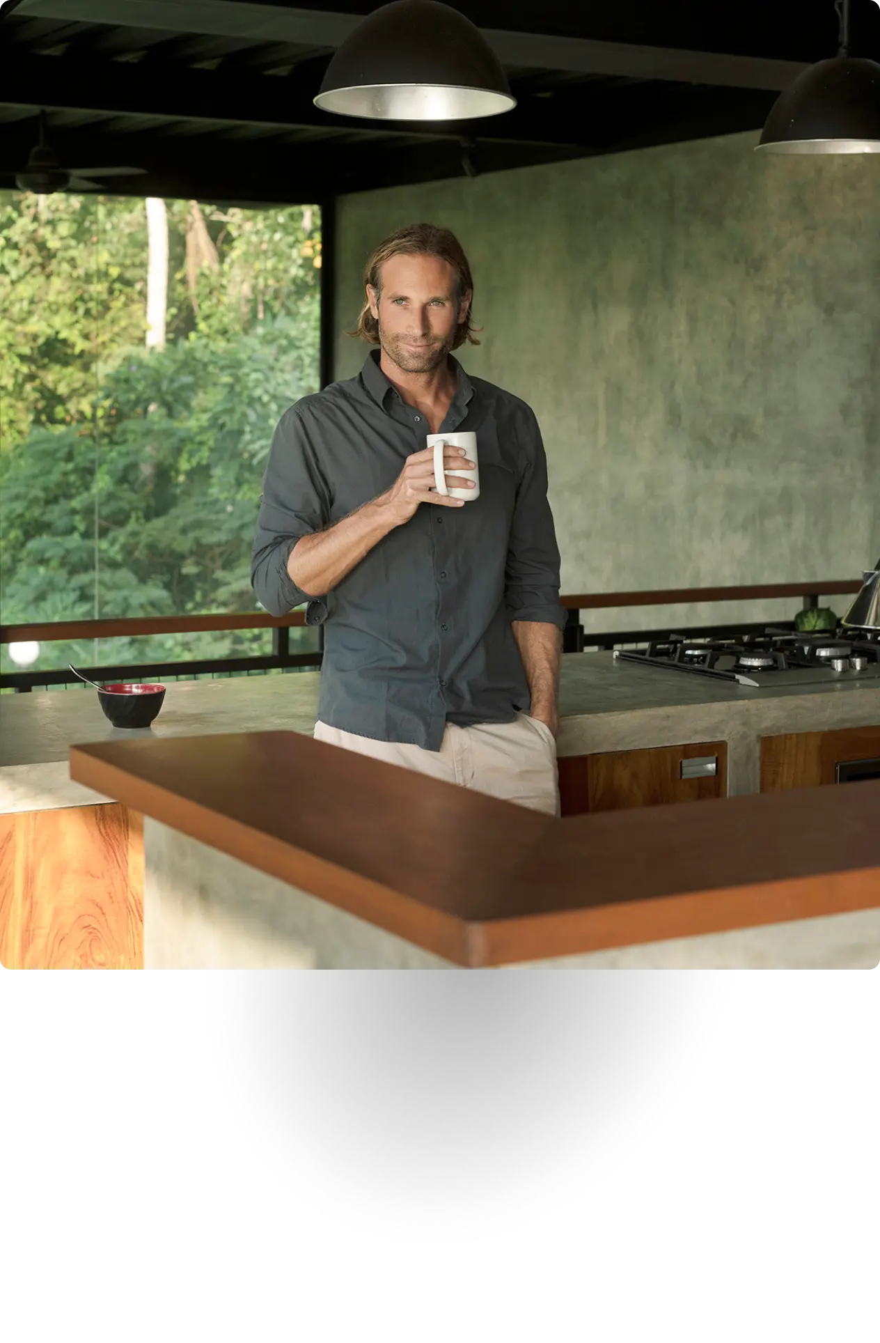 Smiling older man in glasses and a suit jacket.