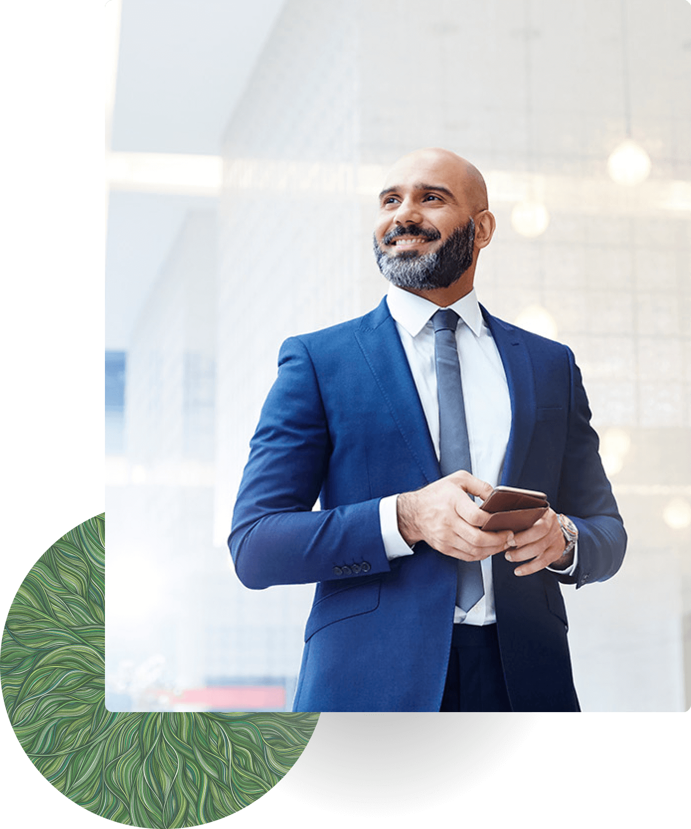 Confident businessman in blue suit holding phone and smiling.