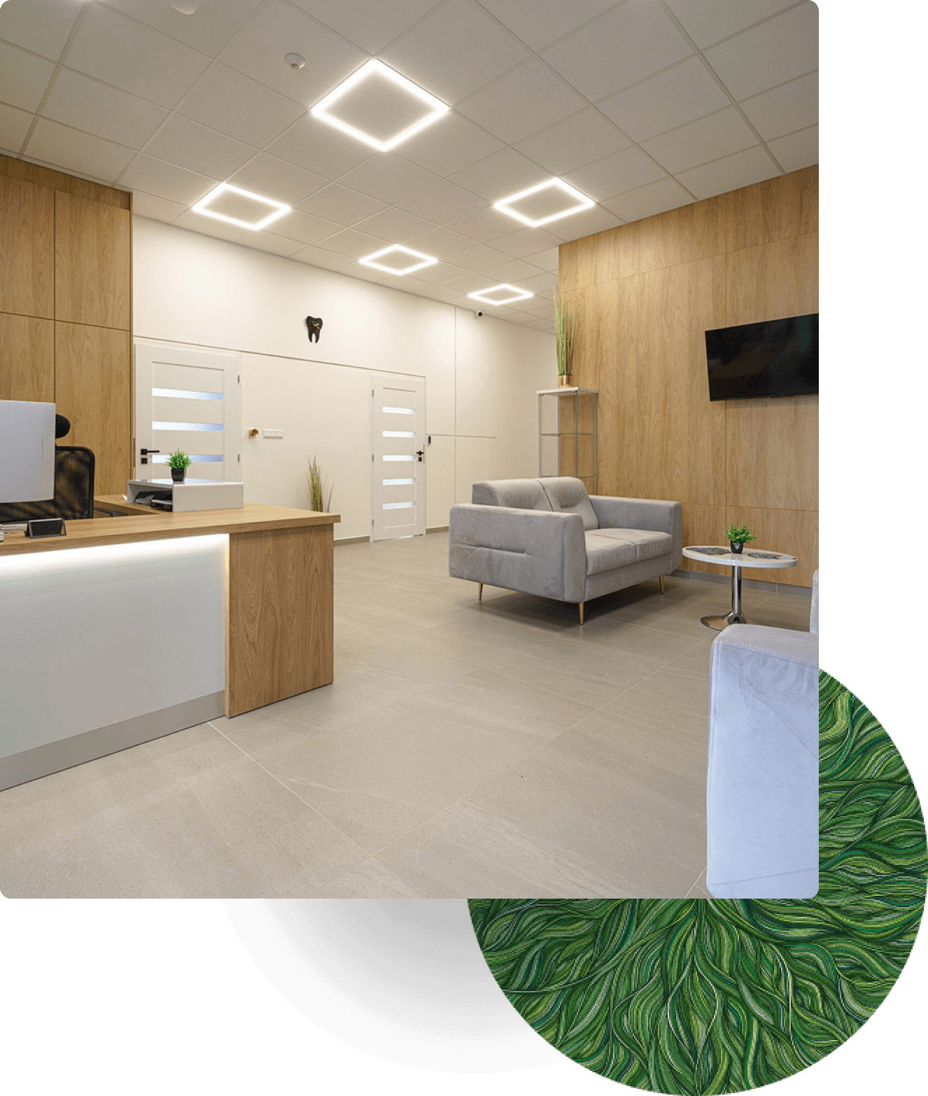 Modern medical office lobby with reception desk, gray sofas, and bright lighting fixtures.