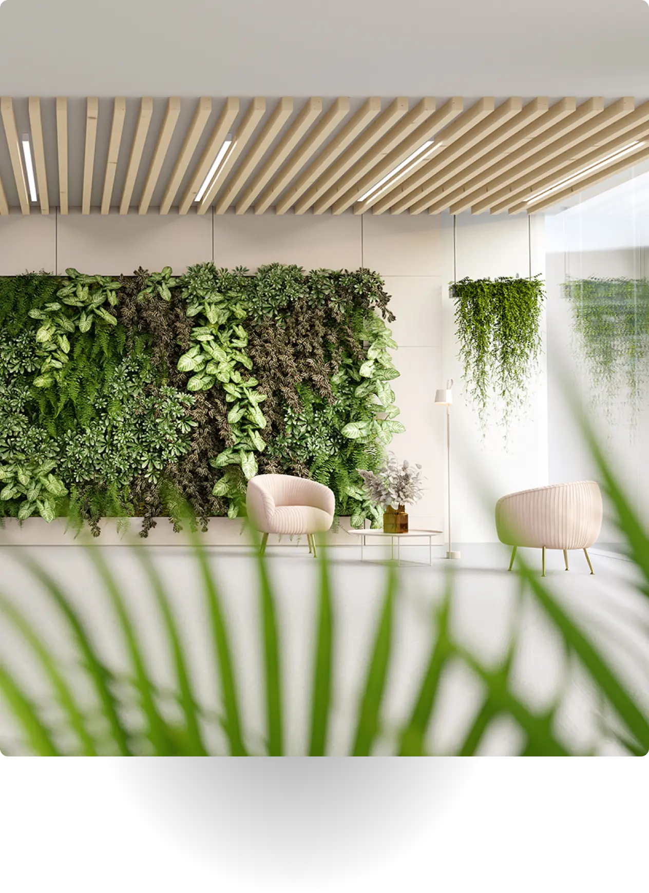 Modern office lounge with a living green wall, two chairs, and natural light.