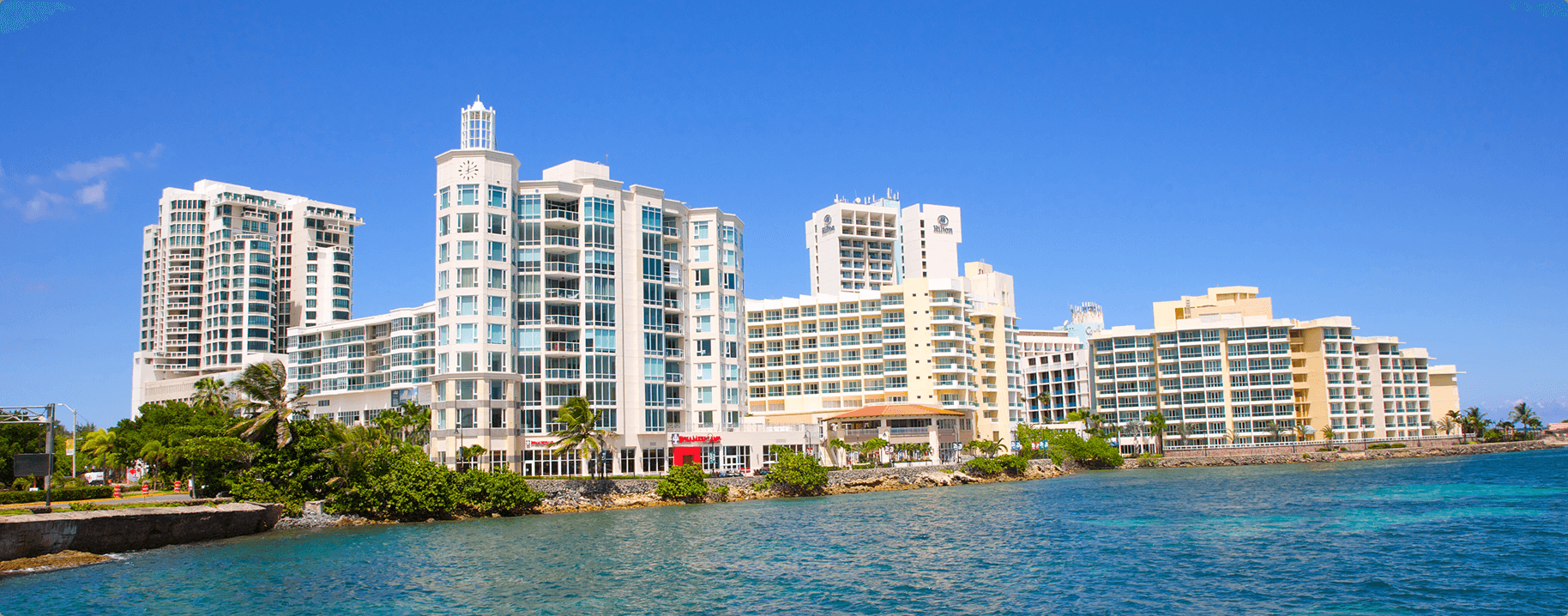 Waterfront condominium buildings under a blue sky in Puerto Rico