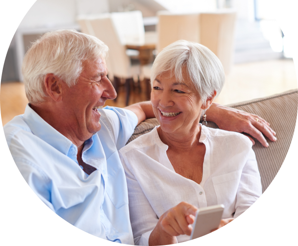 Smiling old couple on phone using Banesco Online Banking platform