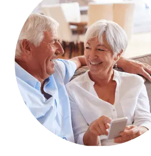 Smiling old couple on phone using Banesco Online Banking platform