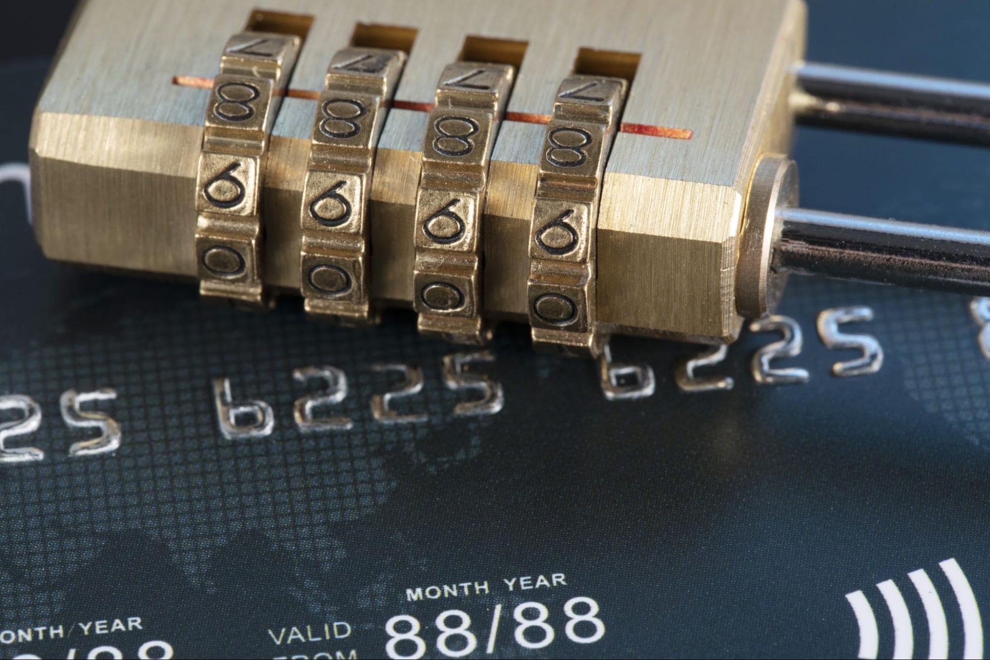 secure banking - a lock sits on a debit card