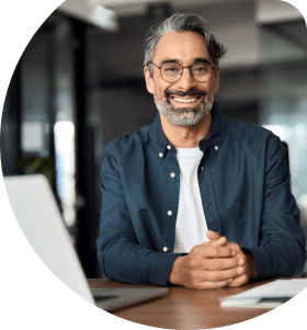 professional-man-glasses-smiling-at-desk-mobile