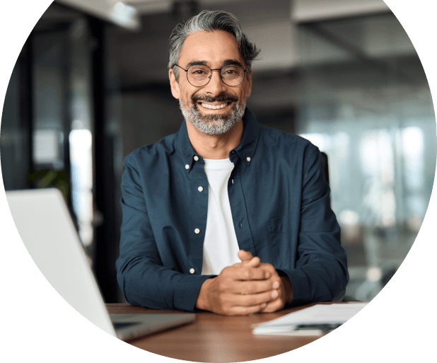 professional-man-glasses-smiling-at-desk
